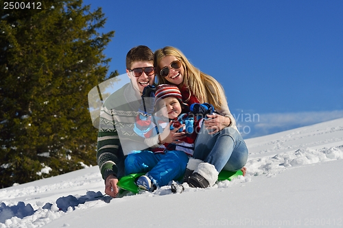 Image of family having fun on fresh snow at winter vacation