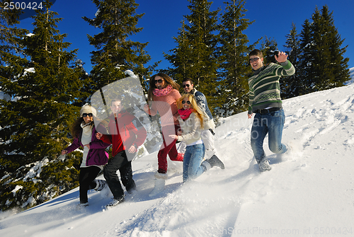 Image of friends have fun at winter on fresh snow