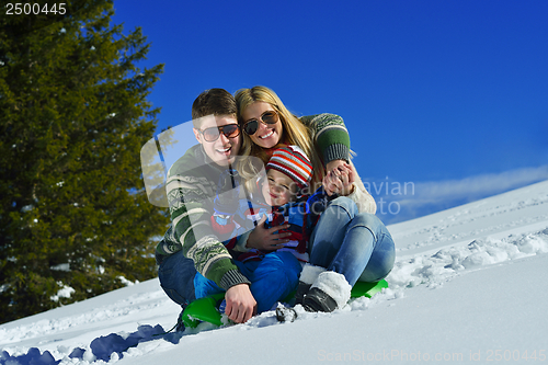 Image of family having fun on fresh snow at winter vacation