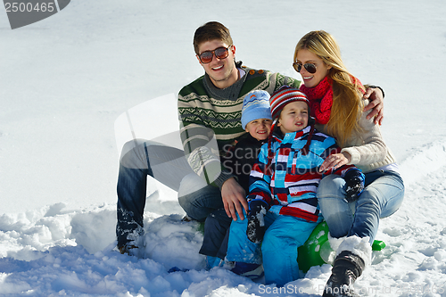 Image of family having fun on fresh snow at winter vacation