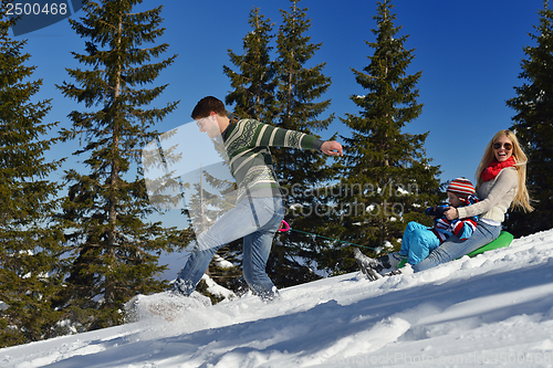 Image of family having fun on fresh snow at winter vacation