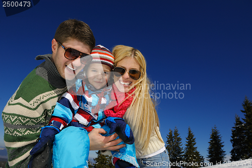 Image of family having fun on fresh snow at winter vacation