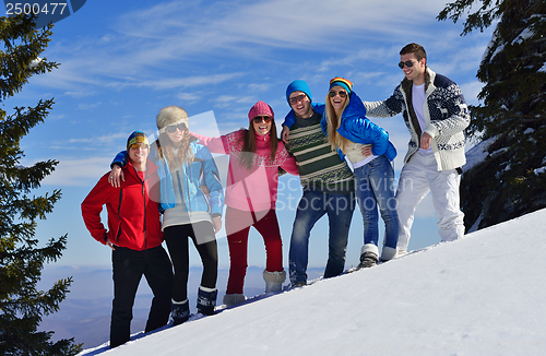 Image of friends have fun at winter on fresh snow