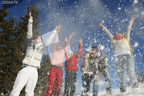 Image of friends have fun at winter on fresh snow