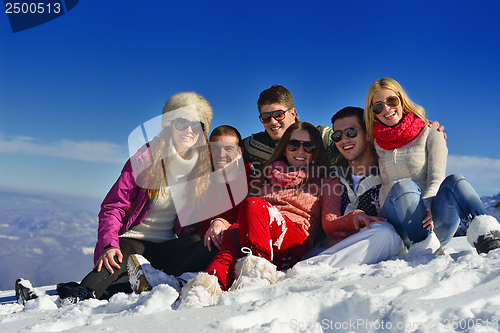 Image of friends have fun at winter on fresh snow