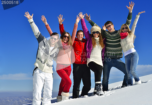 Image of friends have fun at winter on fresh snow