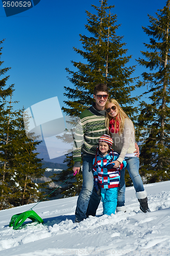 Image of family having fun on fresh snow at winter vacation