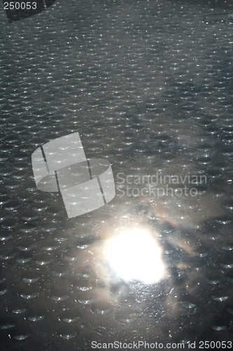 Image of Drops on window with reflecting sun