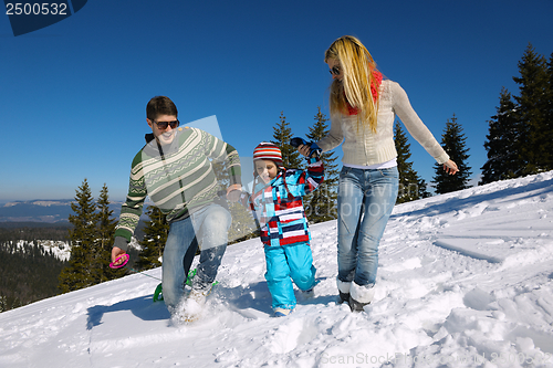Image of family having fun on fresh snow at winter vacation