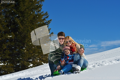 Image of family having fun on fresh snow at winter vacation