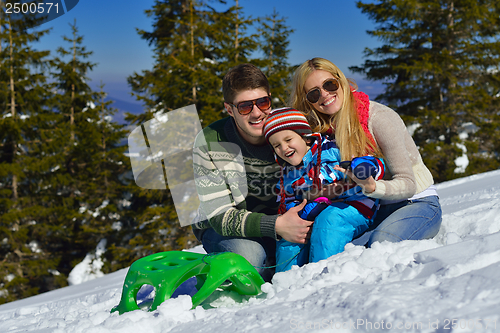 Image of family having fun on fresh snow at winter vacation