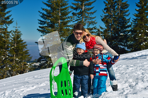 Image of family having fun on fresh snow at winter vacation