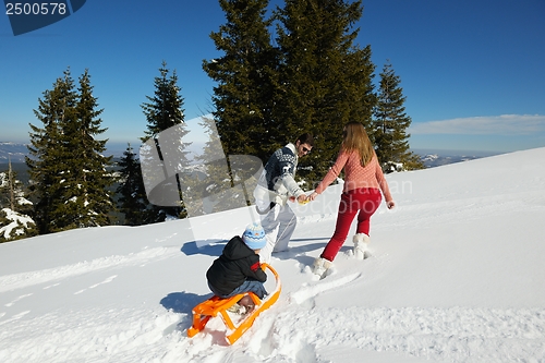 Image of family having fun on fresh snow at winter vacation