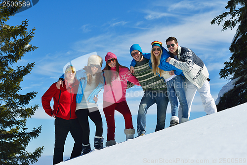 Image of friends have fun at winter on fresh snow