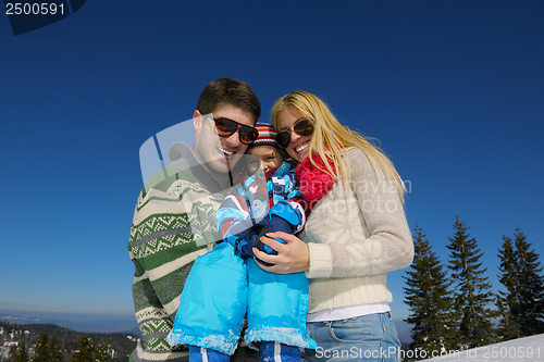 Image of family having fun on fresh snow at winter vacation