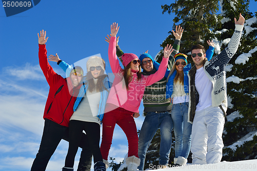 Image of friends have fun at winter on fresh snow
