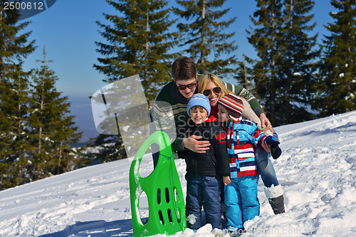 Image of family having fun on fresh snow at winter vacation