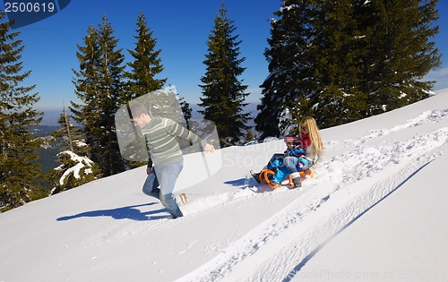 Image of family having fun on fresh snow at winter vacation