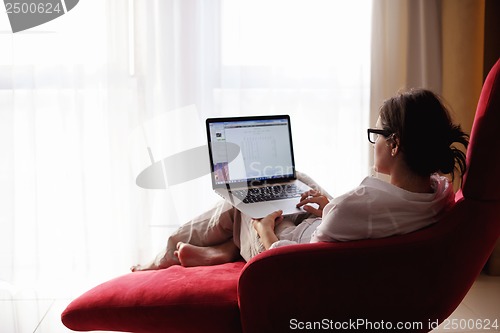 Image of woman using a laptop computer at home