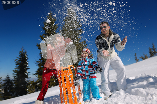 Image of family having fun on fresh snow at winter vacation