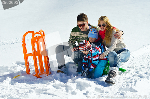Image of family having fun on fresh snow at winter vacation