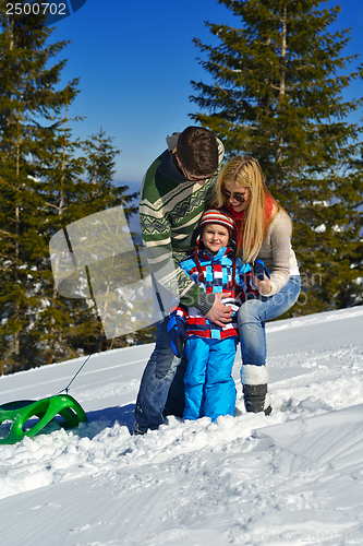 Image of family having fun on fresh snow at winter vacation