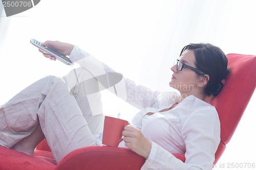 Image of happy young woman relax at home on sofa