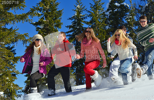 Image of friends have fun at winter on fresh snow