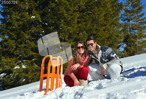 Image of family having fun on fresh snow at winter vacation