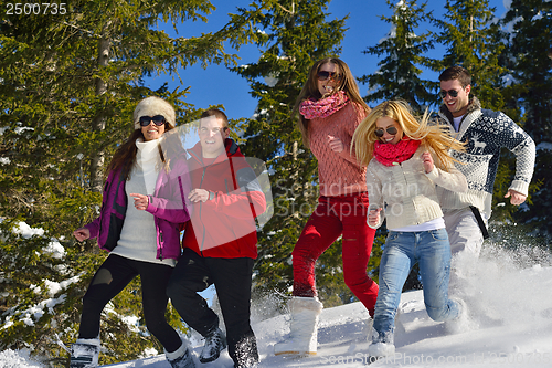 Image of friends have fun at winter on fresh snow