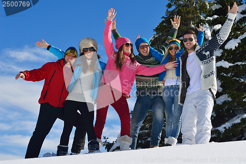Image of friends have fun at winter on fresh snow