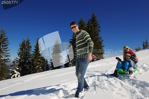 Image of family having fun on fresh snow at winter vacation