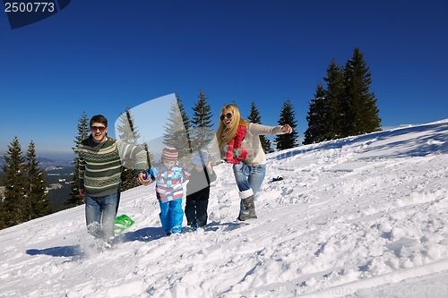 Image of family having fun on fresh snow at winter vacation