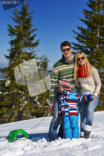 Image of family having fun on fresh snow at winter vacation