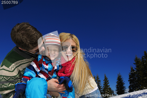 Image of family having fun on fresh snow at winter vacation