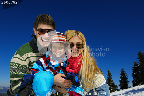 Image of family having fun on fresh snow at winter vacation