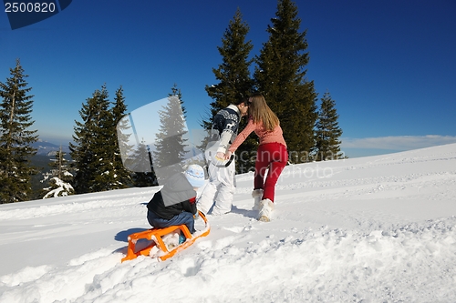 Image of family having fun on fresh snow at winter vacation
