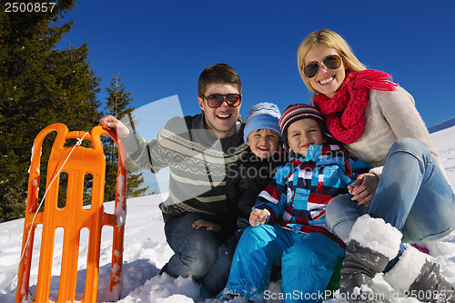 Image of family having fun on fresh snow at winter vacation