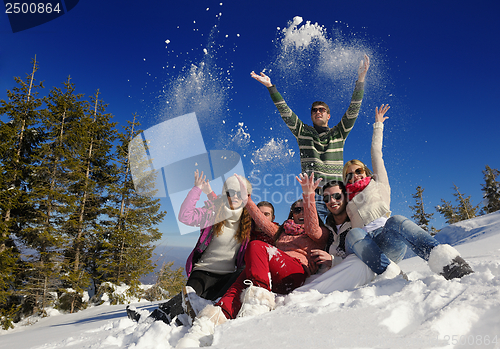 Image of friends have fun at winter on fresh snow