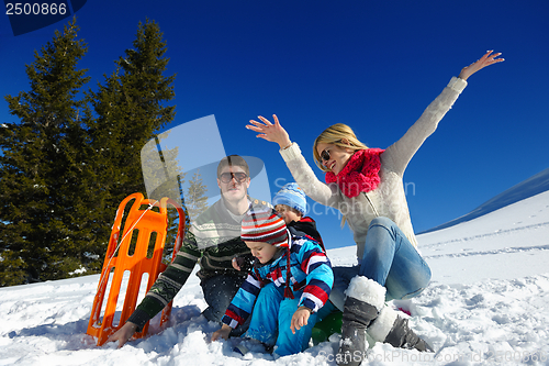 Image of family having fun on fresh snow at winter vacation