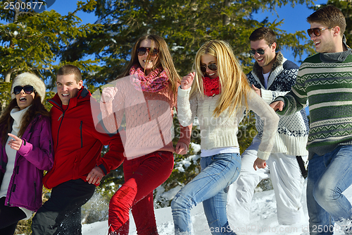 Image of friends have fun at winter on fresh snow
