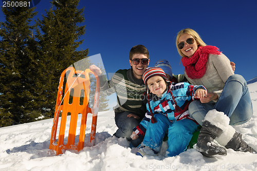 Image of family having fun on fresh snow at winter vacation