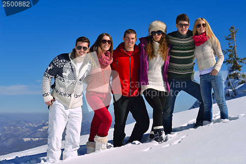 Image of friends have fun at winter on fresh snow
