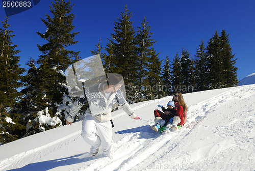 Image of family having fun on fresh snow at winter vacation