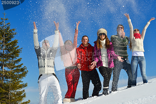Image of friends have fun at winter on fresh snow
