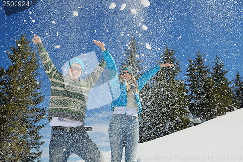 Image of friends have fun at winter on fresh snow