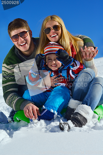 Image of family having fun on fresh snow at winter vacation