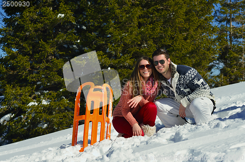Image of family having fun on fresh snow at winter vacation