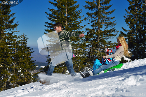 Image of family having fun on fresh snow at winter vacation
