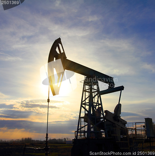 Image of oil pump at sunset